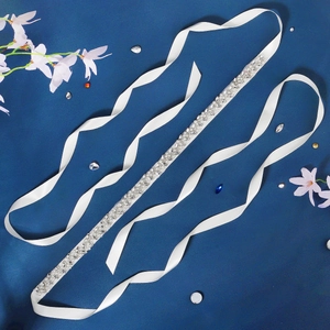 Handmade bridal sash featuring sparkling rhinestones and pearls on white satin ribbon