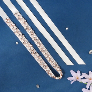Detail of bridal waist belt featuring marquise crystals and small pearls on ivory ribbon