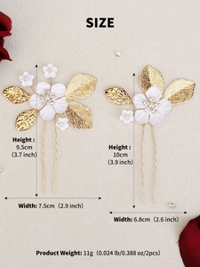 Detail showing two handmade bridal hair combs with white silk flowers and gold leaves