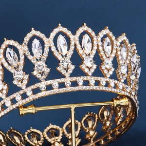 Luxurious gold crystal bridal tiara with rhinestones shown in a detailed side profile view
