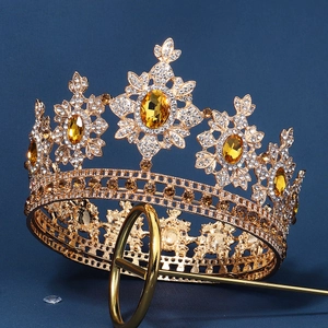 Macro shot of gold crown with intricate floral details and yellow amber gemstones