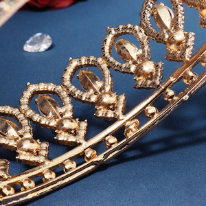 Baroque gold alloy bridal crown with intricate filigree and sparkling crystal rhinestones