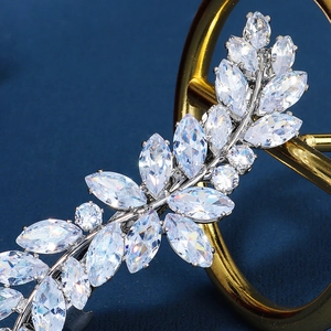 Elegant silver leaf hair clip with marquise-cut rhinestones on dark blue background