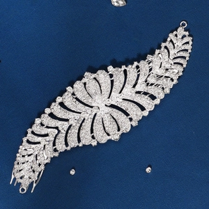 Detailed view of bridal silver hair comb with sparkling rhinestones on blue background
