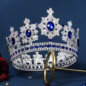Luxurious royal blue crystal crown with silver alloy base and intricate floral patterns