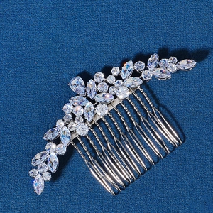 Macro detail of bridal hair comb with silver flower patterns and sparkling zircon stones