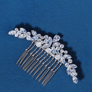 Macro view of silver floral bridal hair comb with marquise cut zircon crystals