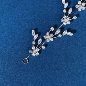 Detailed close-up of floral silver bridal headpiece with sparkling zircon crystals