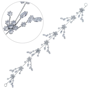Detailed macro view of silver bridal hair vine featuring crystal flowers and leaves