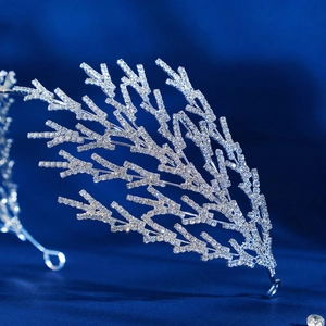 Detailed macro view of a silver coral-shaped bridal crown with sparkling rhinestones