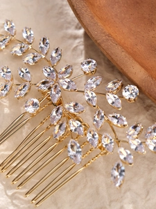 Detailed close-up of a gold floral hair comb with marquise cut zircon petals and crystals
