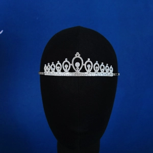 Close-up of a silver alloy bridal crown with sparkling rhinestones and hollow oval patterns