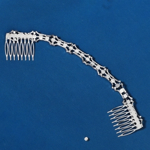 Detail of silver bridal hair comb with sparkling rhinestones and crystal chain links