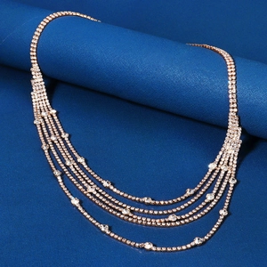 Macro view of luxurious rose gold layered tassel chain with sparkling white rhinestones