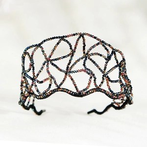 Detail of handmade wavy black beaded headband with colorful AB crystal rhinestones