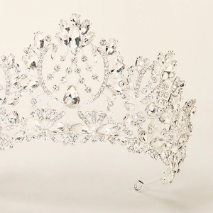 Detailed macro view of silver bridal crown showing intricate crystal settings and patterns