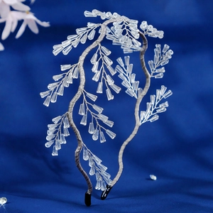 Detailed view of handcrafted crystal beaded bridal headband with silver branch design