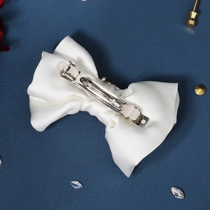 Elegant white satin bow hair clip with silver spring metal back for hair styling