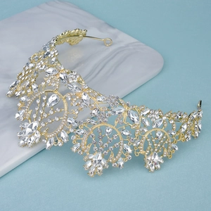 Detailed close-up of a golden bridal tiara with intricate crystal flower patterns