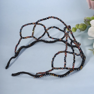 Close-up of black beaded headband featuring a woven mesh crown design with AB rhinestones