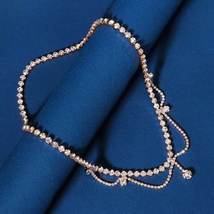 Detailed macro view of bohemian gold head chain with layered rhinestones and crystal drop