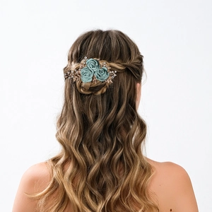 Detailed close-up of blue rose bridal hair comb with rhinestone leaves on model's hair