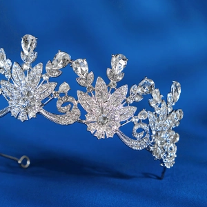 Close-up of silver bridal crown with pear-cut crystals and floral rhinestone patterns