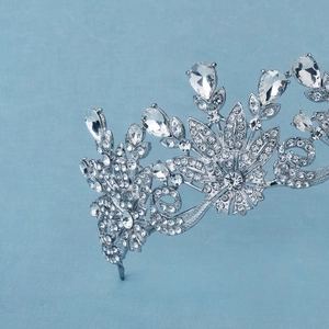 Close-up of sparkling silver bridal tiara with intricate crystal floral and leaf patterns