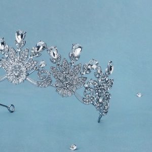 Detailed macro view of silver bridal crown with shimmering rhinestones and water drop crystals