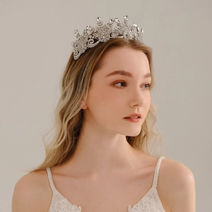 Silver bridal crown with crystal rhinestones in baroque floral design on a model