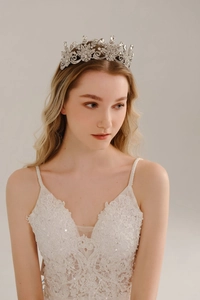 Close-up of elegant silver bridal crown with intricate floral crystals and rhinestones
