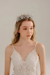 Close-up of bridal crystal crown with silver alloy floral hollow design and rhinestones