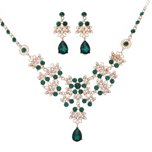 Vintage gold-plated jewelry set with emerald green crystals and hollow necklace details
