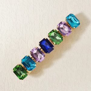 Golden spring hair clip featuring seven colorful rectangular rhinestones in a row