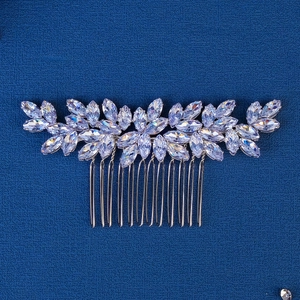 Macro detail of marquise-cut crystal leaves on a bridal hair comb with silver metal teeth