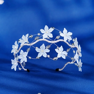 Exquisite crystal flower headband with silver wired branches on dark silk background