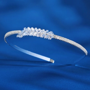 Elegant silver bridal headband with marquise zirconia leaves on luxury blue silk backdrop