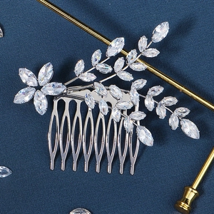 Macro view of silver bridal hair comb with marquise-cut zircon floral leaf designs