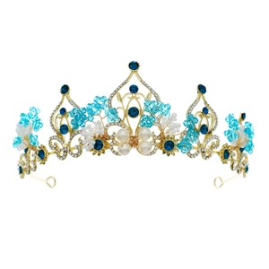 Baroque golden bridal crown with blue crystals and white pearls on white background
