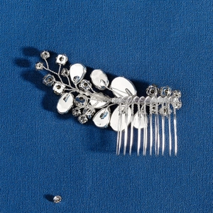Handmade silver bridal hair comb with marquise rhinestones and crystals on blue background