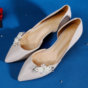 Elegant pointed flats with handmade pearl floral clips and rhinestones on blue fabric