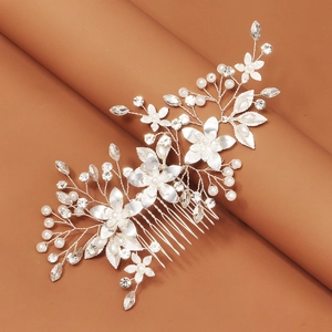 Detail of silver floral hair comb with pearls and rhinestones for bridal wedding hairstyles