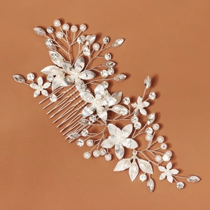 Detailed view of silver bridal hair comb with pearls, crystals and floral vine ornaments