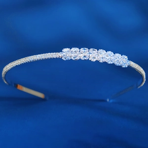 Macro shot of silver bridal headband with double-row oval cubic zirconia on silk