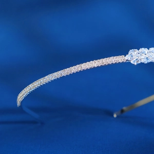 Macro shot of silver bridal headband featuring marquise gemstone flower clusters and crystals