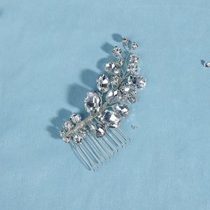 Close-up of handmade bridal hair comb with clear crystals and silver metal wire details