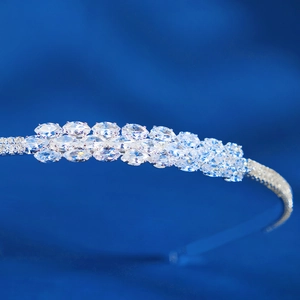 Macro detail of silver bridal headband with marquise cut cubic zirconia on blue velvet