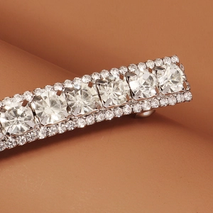 Macro detail of a vintage silver hair clip with large rhinestones and pavé crystal edges