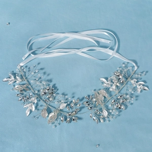 Detailed macro view of handmade bridal crystal headband with pearls and silver leaves