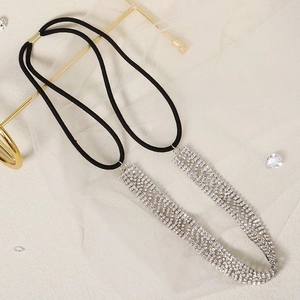 Close-up of sparkling silver rhinestones on a black elastic headband for wedding
